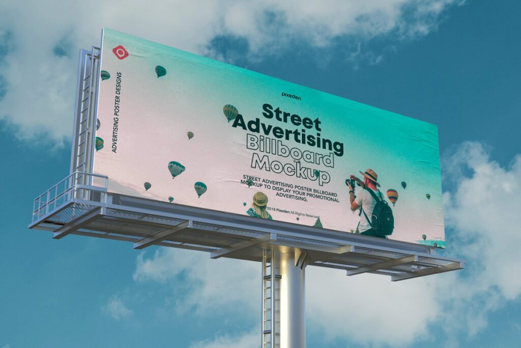 Large outdoor advertising billboard mockup featuring a travel theme with a person taking a photo, hot air balloons, and "Street Advertising Billboard Mockup" text against a blue sky.