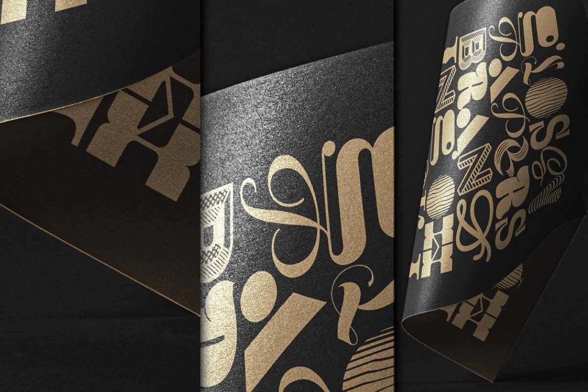 Three distinct views of black paper mockups with golden foil stamping, showing folded, flat, and curved paper with intricate typographic and geometric designs.