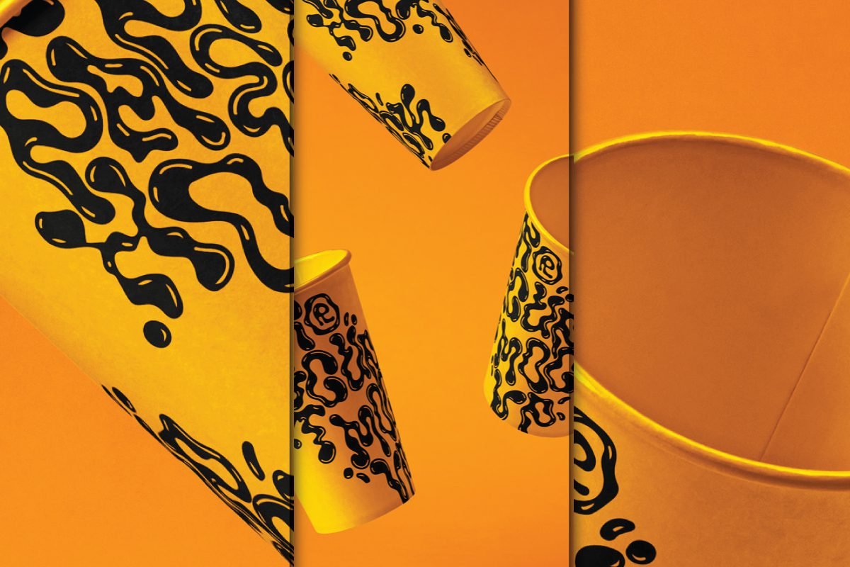 Multiple yellow paper coffee cup mockups with black abstract drip patterns appearing to fall or float against a vibrant orange background.