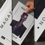 Magazine front cover mockup being held by a hand, featuring a dark-skinned model and "MAGAZINE SHOWCASE" text, with other magazine views on a textured surface.