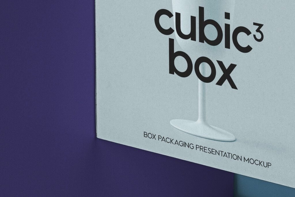 A close-up of a light grey "Cubic Box Packaging Mockup" featuring "cubic³ box" text and a white goblet illustration, set against a deep purple background.