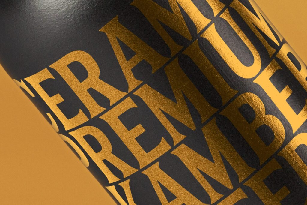 A close-up of a matte black bottle featuring bold, metallic gold typography, showcasing a luxurious branding effect, ideal for a Dark Bottle Mockup PSD.