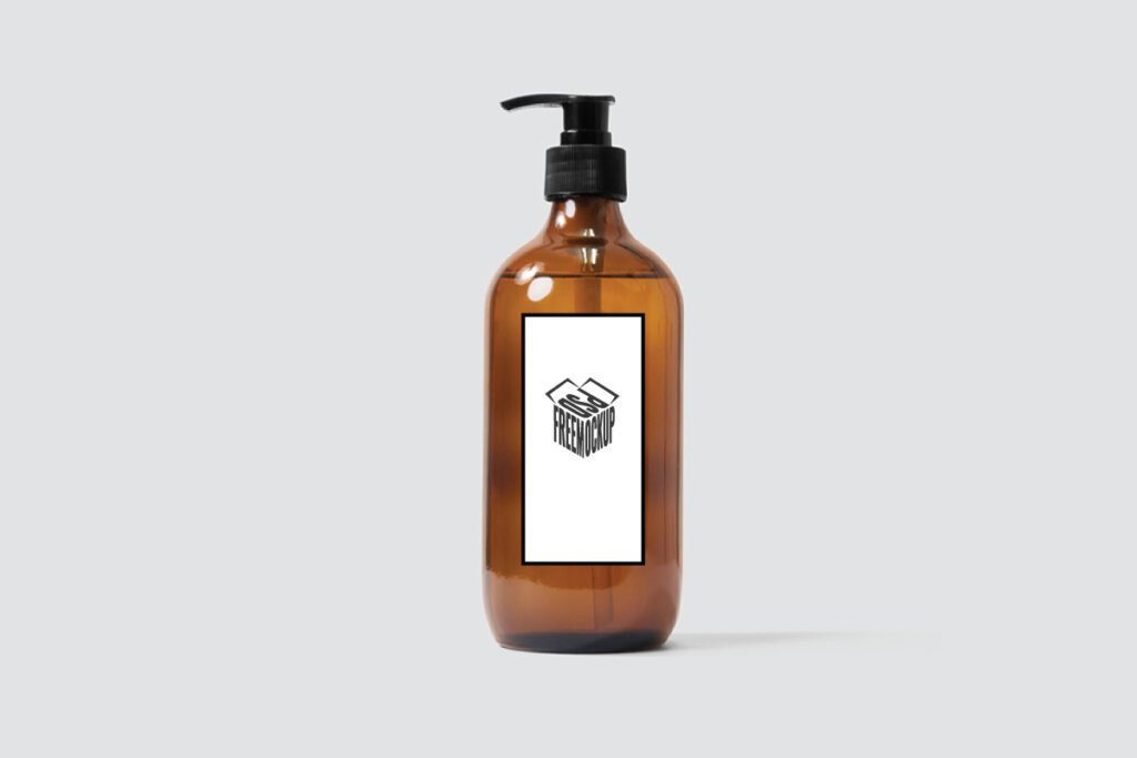 Amber Glass Dispenser Bottle Label Mockup PSD displaying a single amber glass bottle with a black pump dispenser and a white label featuring a black PSD FREEMOCKUP box logo.