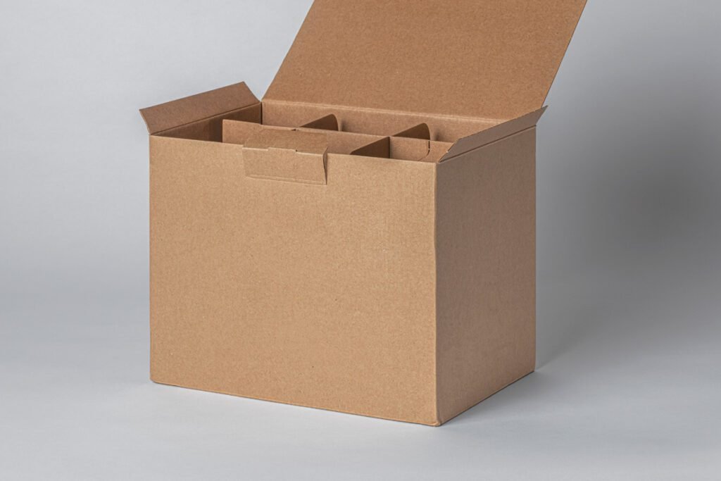 An open, unbranded Kraft cardboard box with internal dividers, presented on a clean white and gray gradient background, ready for product placement or branding.