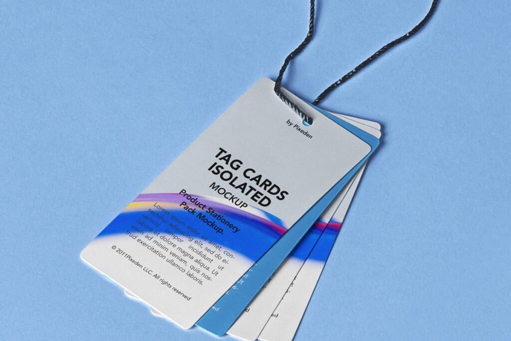 Three white product tags, layered and suspended by a black string, featuring "TAG CARDS ISOLATED MOCKUP," "Product Stationery Pack Mockup," lorem ipsum text, and a colorful abstract design on a blue background.