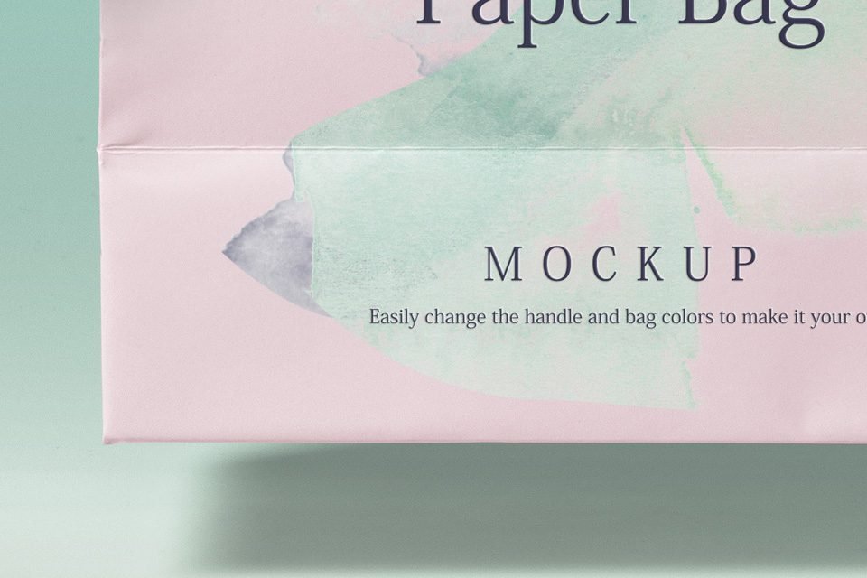 A close-up of a "Shopping Bag PSD Mockup" showing the bottom corner of a pink paper bag with watercolor green and grey designs, featuring "MOCKUP" text and instructions to customize colors.