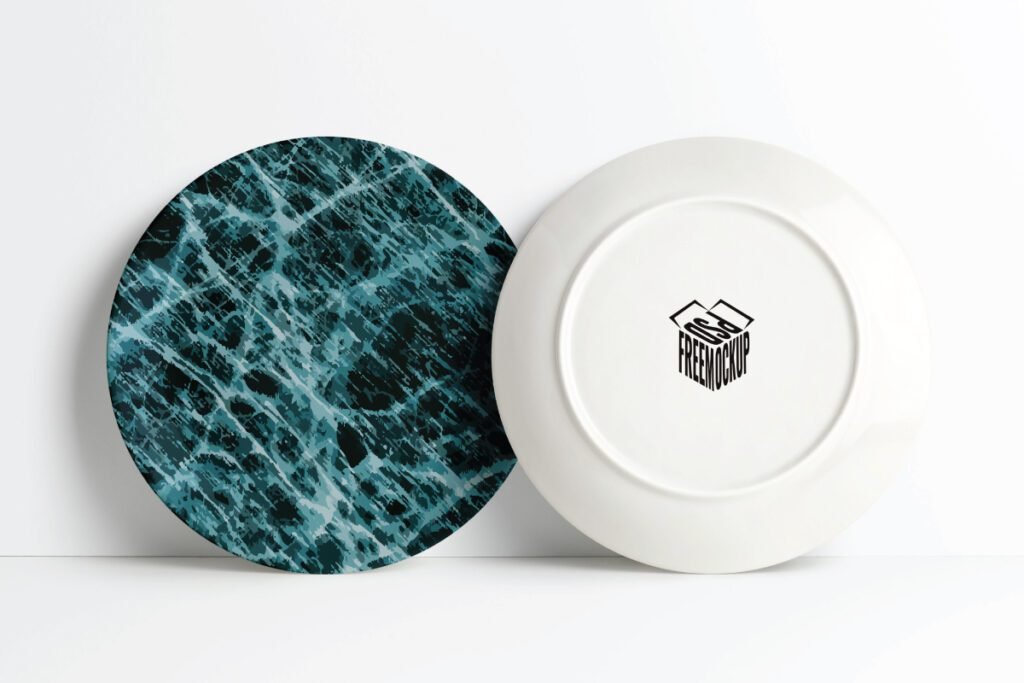 Best Realistic Ceramic Plate Wrap Mockup PSD showcases two round plates, one with a blue marble design and another showing its white underside with a black box logo.