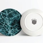 Best Realistic Ceramic Plate Wrap Mockup PSD showcases two round plates, one with a blue marble design and another showing its white underside with a black box logo.