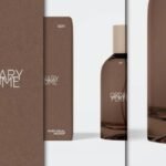 A close-up, split view of a dark amber perfume bottle mockup and its matching brown packaging box, both featuring "ORDINARY PERFUME" branding.