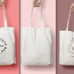 Lifestyle Canvas Tote Bag Mockup PSD displays three hands holding plain white canvas tote bags against varying pink and brown backgrounds. One bag has a black circular logo, another is blank, and the third shows a brown version of the logo with Free mockup text.