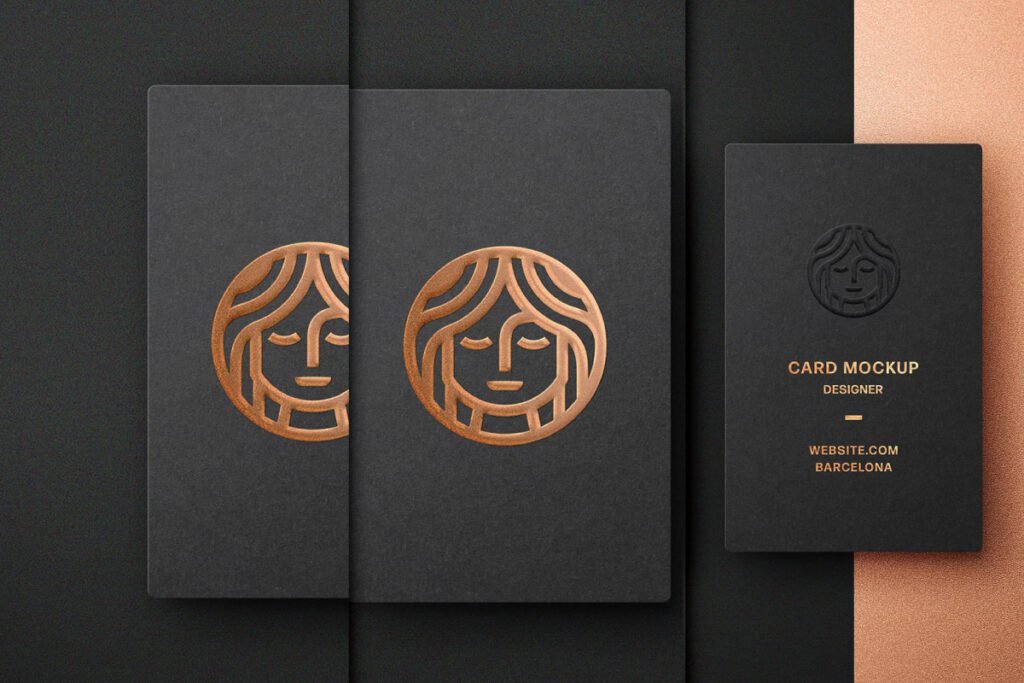 Three foil embossed business card mockup circular logo of a stylized face. Two cards are open, revealing a similar embossed logo.